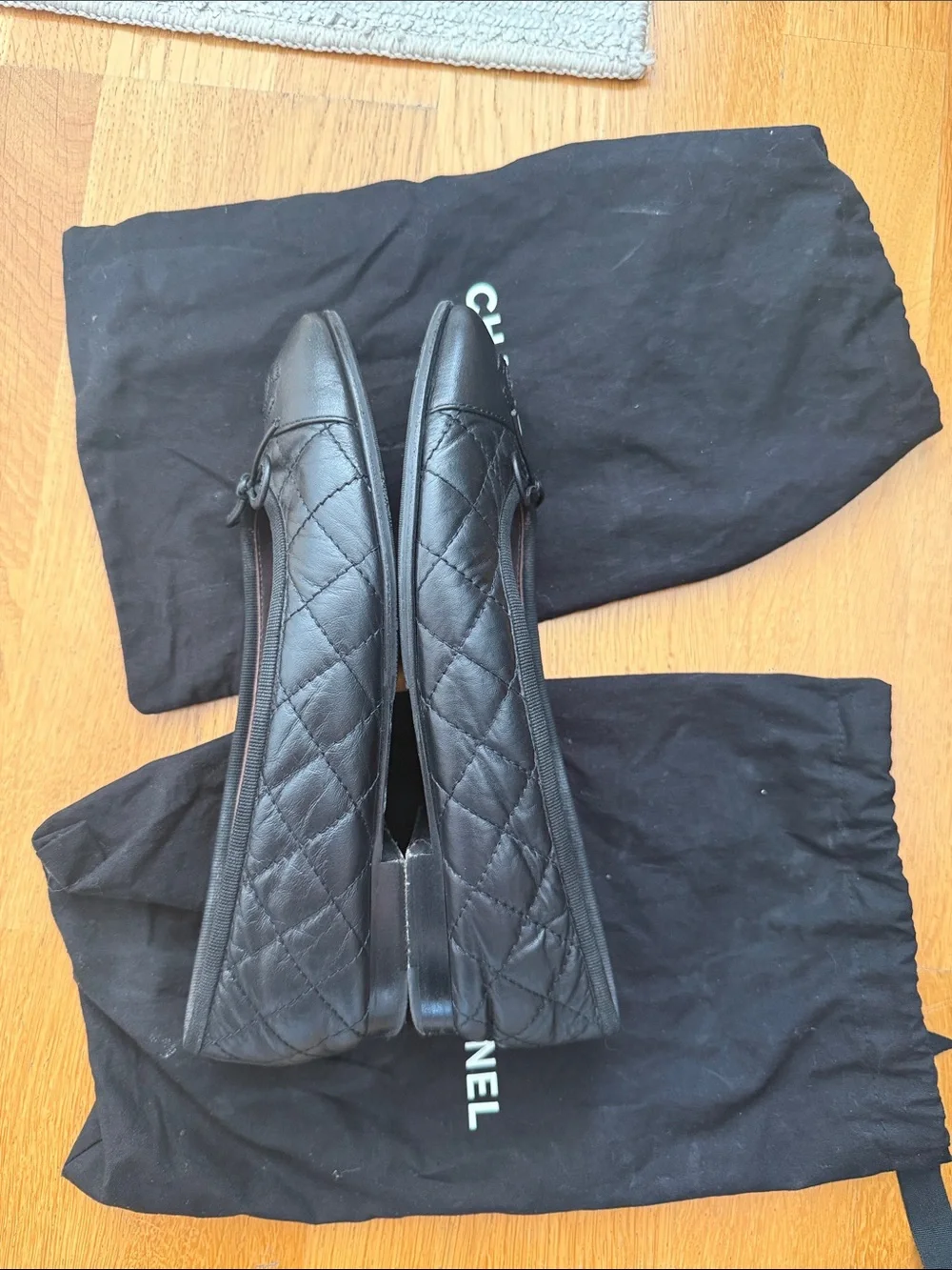 CHANEL Black Quilted Leather Ballet Flats with CC Logo and Bow